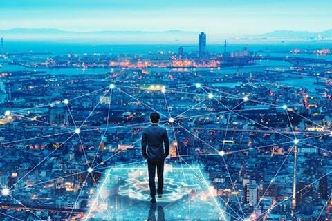 A businessman stands on a digital platform overlooking a city with glowing network connections.